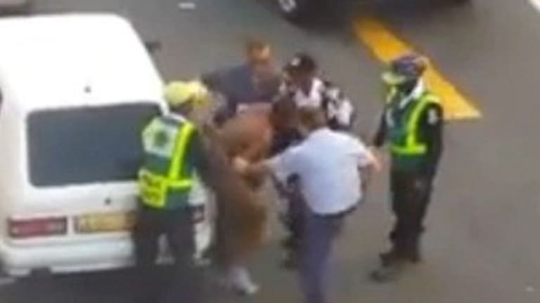 Gang of Cops Strip Down and Beat Man During Arrest, Then Arrest the Girl Who Filmed It