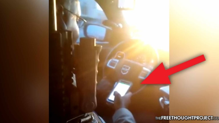 WATCH: Handcuffed Man Records Cop Breaking the Law From Inside the Patrol Car