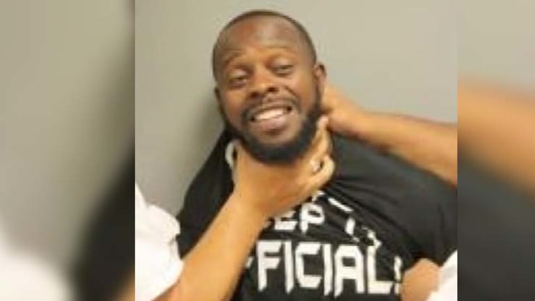 Man's Mugshot Captures Cops Choking Him for the Alleged 'Crime' of Smiling