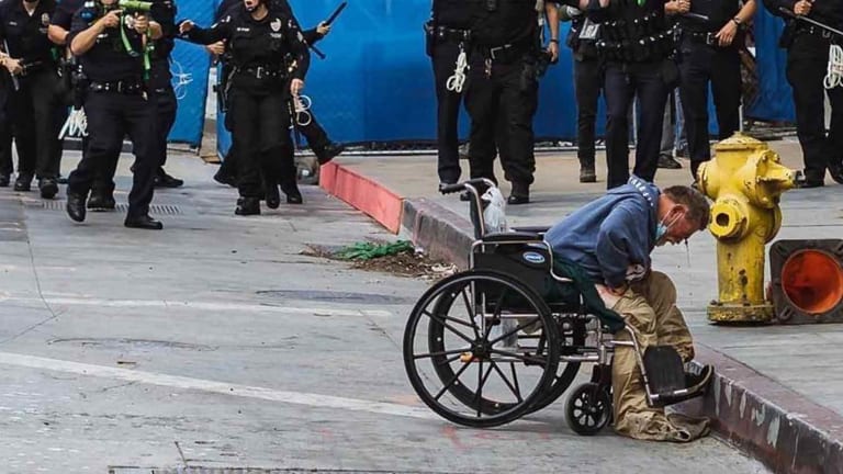 Sadistic Riot Cops Shoot Innocent Wheelchair-Bound Homeless Man in the Head