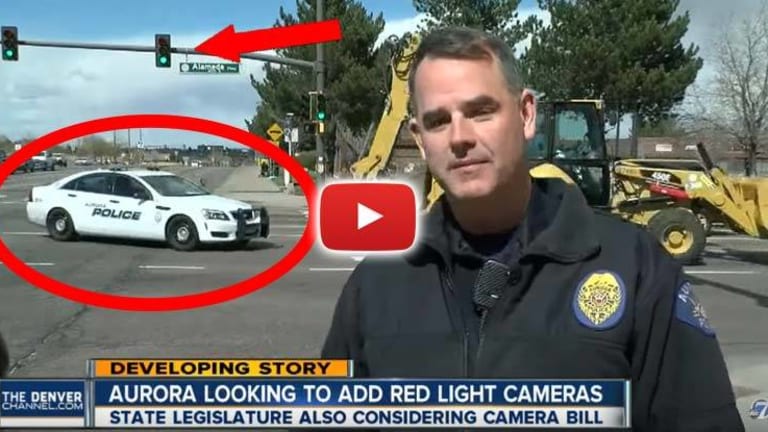 VIDEO: While Officer Says Running Red Lights is Illegal, Behind Him, a Cop Runs a Red Light