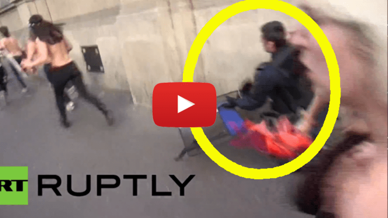 Protest Suppression FAIL: Cop Tries to Tackle Topless Protesters, Tackles Wall Instead