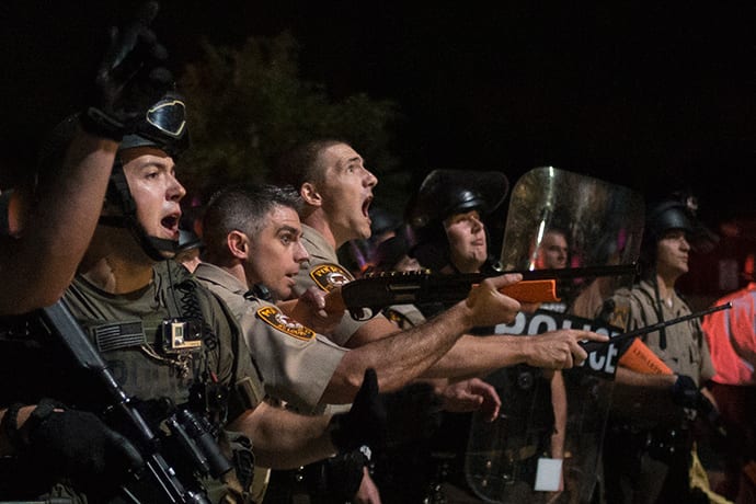 Security forces charge demonstrators after being hit by water bottles during a protest against the shooting of unarmed black teen Michael Brown in Ferguson, Missouri August 20, 2014 (Reuters / Adrees Latif)