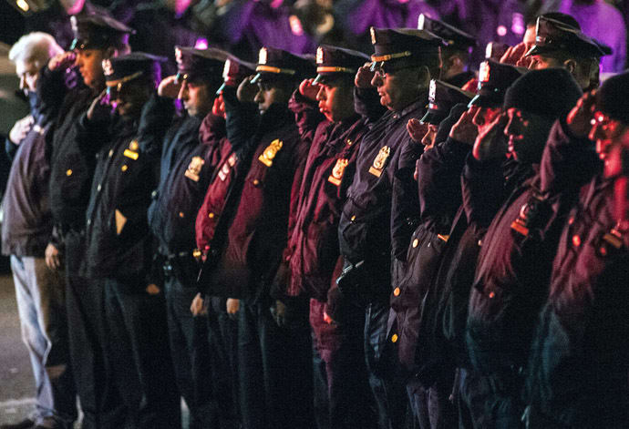 Police officers line the route as vehicles containing the bodies of the two New York Police officers who were shot dead drive by in the Brooklyn borough of New York, December 20, 2014. (Reuters/Stephanie Keith)