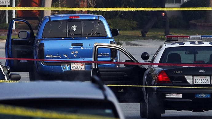 Police detectives investigate a shooting incident involving a blue Toyota Tacoma pickup truck in Torrance, California, February 7, 2013. Police opened fire on the vehicle in a case of mistaken identity while searching for former Los Angeles police officer Christopher Jordan Dorner (Reuters / Patrick Fallon)