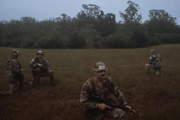 Soldiers practicing tactical movements in the pouring rain. [Source: nytimes.com]