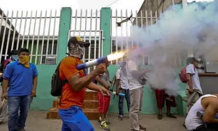 A masked protester discharges his home-made mortar in the Monimbó neighborhood. [Source: theguardian.com]