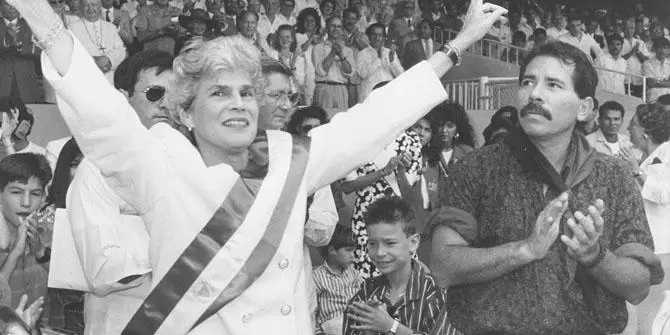 Violeta Chamorro receiving the presidential sash from Daniel Ortega in 1990. [Source: blogs.lse.ac.uk]