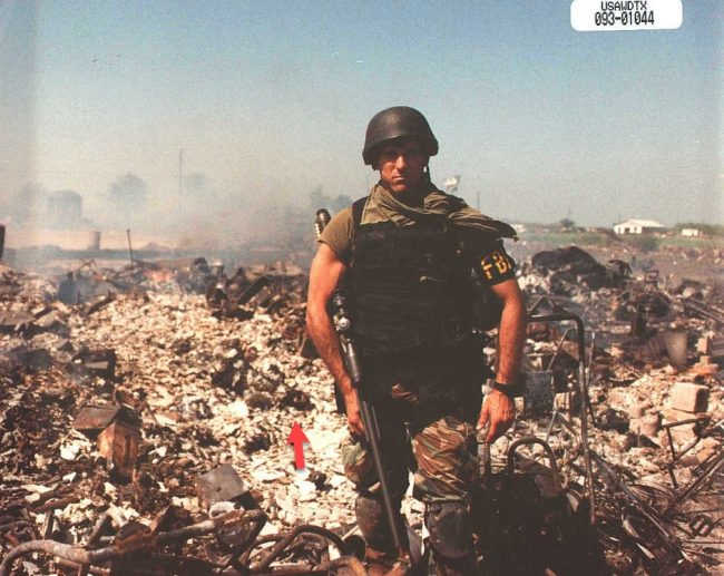 Here is another Fed posing with 76-year-old Raymond Freisen’s burned and disfigured corpse.