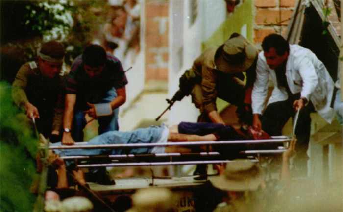 Pablo Escobar’s body being lowered from the rooftop where he was killed by Colombian state security forces, assisted by the CIA on December 2, 1993. But Escobar’s killing did little to curtail the drug trade out of Colombia, which expanded markedly after the Clinton and Bush administrations instituted the ill-conceived Plan Colombia. [Source: themobmuseum.org]