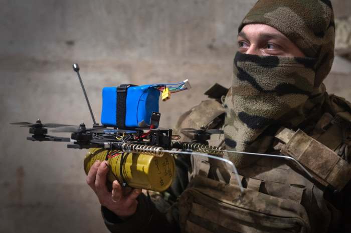 Ukrainian soldier displaying home-made drone laced with explosives. Mexican drug cartel operatives infiltrated the Ukraine International Legion in order to obtain know-how in the use of this deadly technology. [Source: defensenews.com]