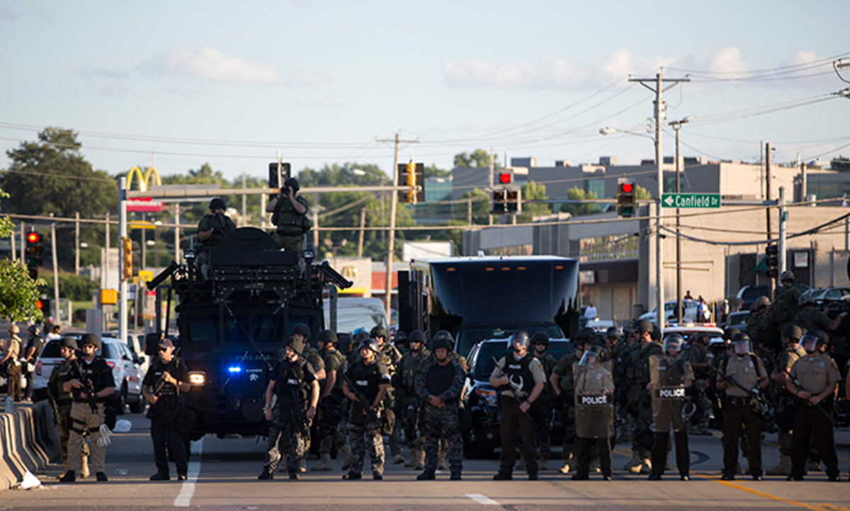 Police officers keep watch while demonstrators (not pictured) protest the death of black teenager Michael Brown in Ferguson, Missouri August 12, 2014 (Reuters / Mario Anzuoni)
