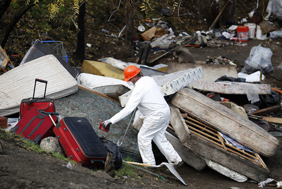 Authorities break down a homeless encampment known as "The Jungle" in San Jose, California December 4, 2014. (Reuters/Beck Diefenbach)