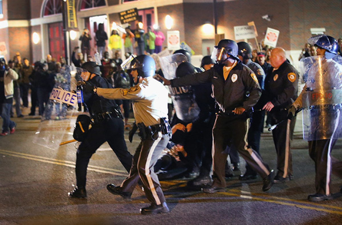 Police face off with demonstrators outside the police station as protests continue in the wake of 18-year-old Michael Brown's death on October 22, 2014 in Ferguson, Missouri. (AFP Photo/Scott Olson)