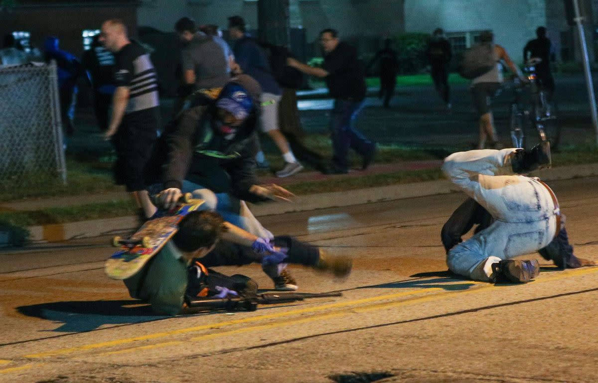  Kyle Rittenhouse, 17, of Antioch, appears to be hit with a skateboard during a confrontation with protesters in Kenosha on Aug. 25, 2020. The man with the skateboard, later identified as Anthony Huber, 26, of Silver Lake approached Rittenhouse as he was on his back, prosecutors wrote. Huber reached for the gun as the skateboard hit Rittenhouse’s shoulder before the alleged gunman fired one shot, and Huber staggered away and collapsed, prosecutors alleged. (Tayfun Coskun/Anadolu Agency via Getty Images)