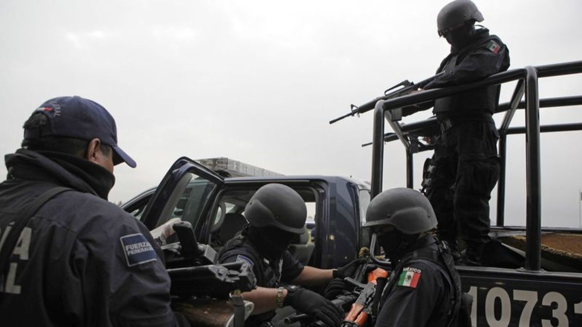 Seized weapons from alleged members of the Beltran-Leyva drug cartel are taken away by federal agents after a news conference in Mexico City on June 26, 2009.