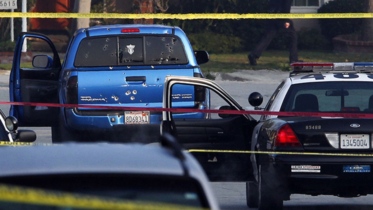 Police detectives investigate a shooting incident involving a blue Toyota Tacoma pickup truck in Torrance, California, February 7, 2013. Police opened fire on the vehicle in a case of mistaken identity while searching for former Los Angeles police officer Christopher Jordan Dorner (Reuters / Patrick Fallon)