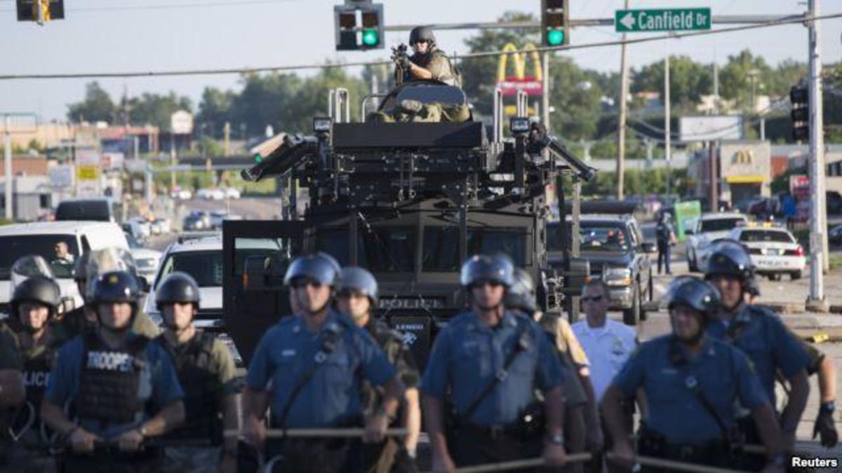Riot police stand guard as demonstrators protest the shooting death of teenager Michael Brown in Ferguson, Missour: Reuters