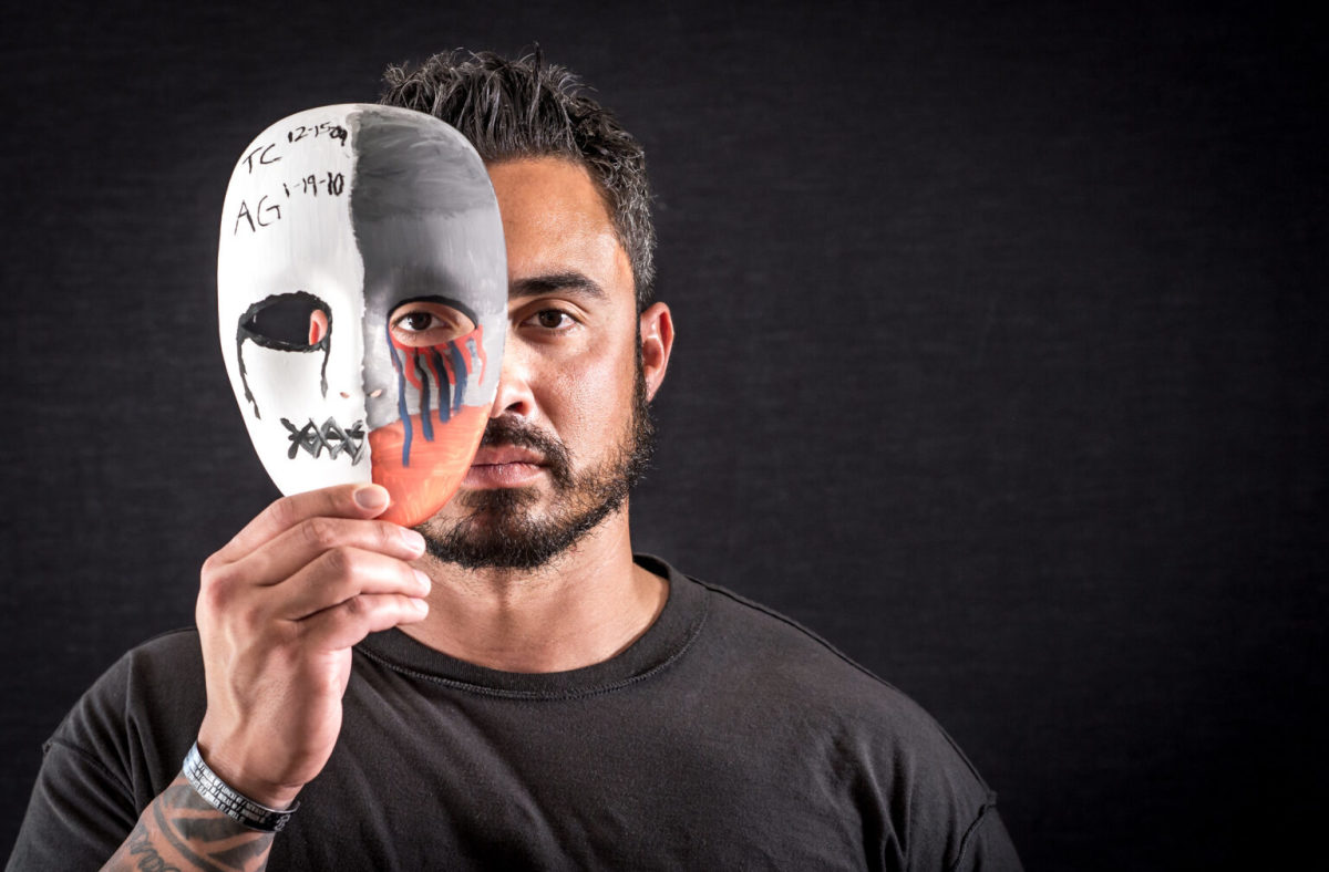 A former explosive ordnance disposal technician suffering from PTSD and traumatic brain injury after combat tours in Afghanistan and Iraq displays a mask he painted in Hanover, Pa., 2017. (U.S. Air Force, J.M. Eddins Jr.)